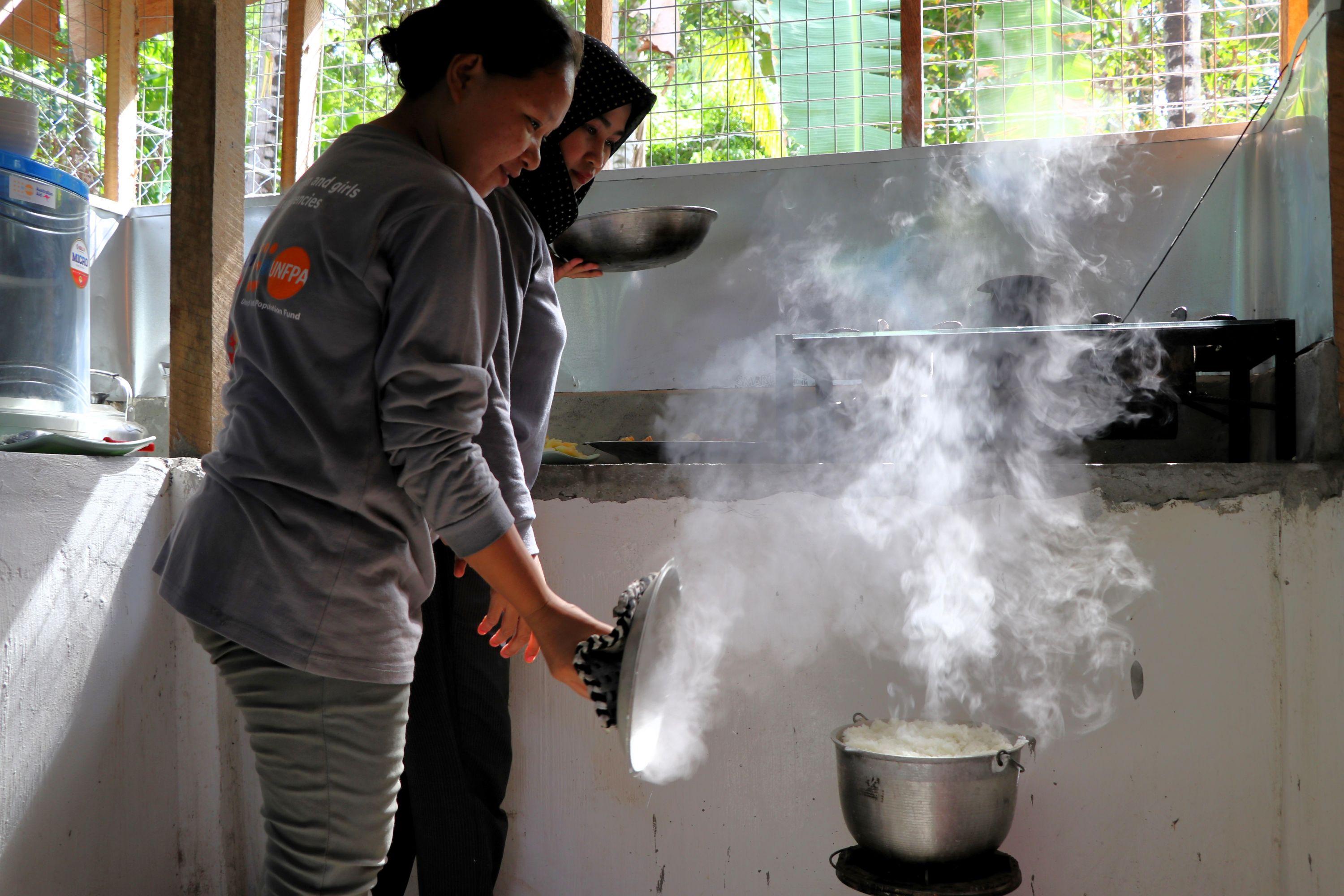 WFS facilitators in Talitay, Maguindanao del Norte prepare food for participants of a nutrition programme.