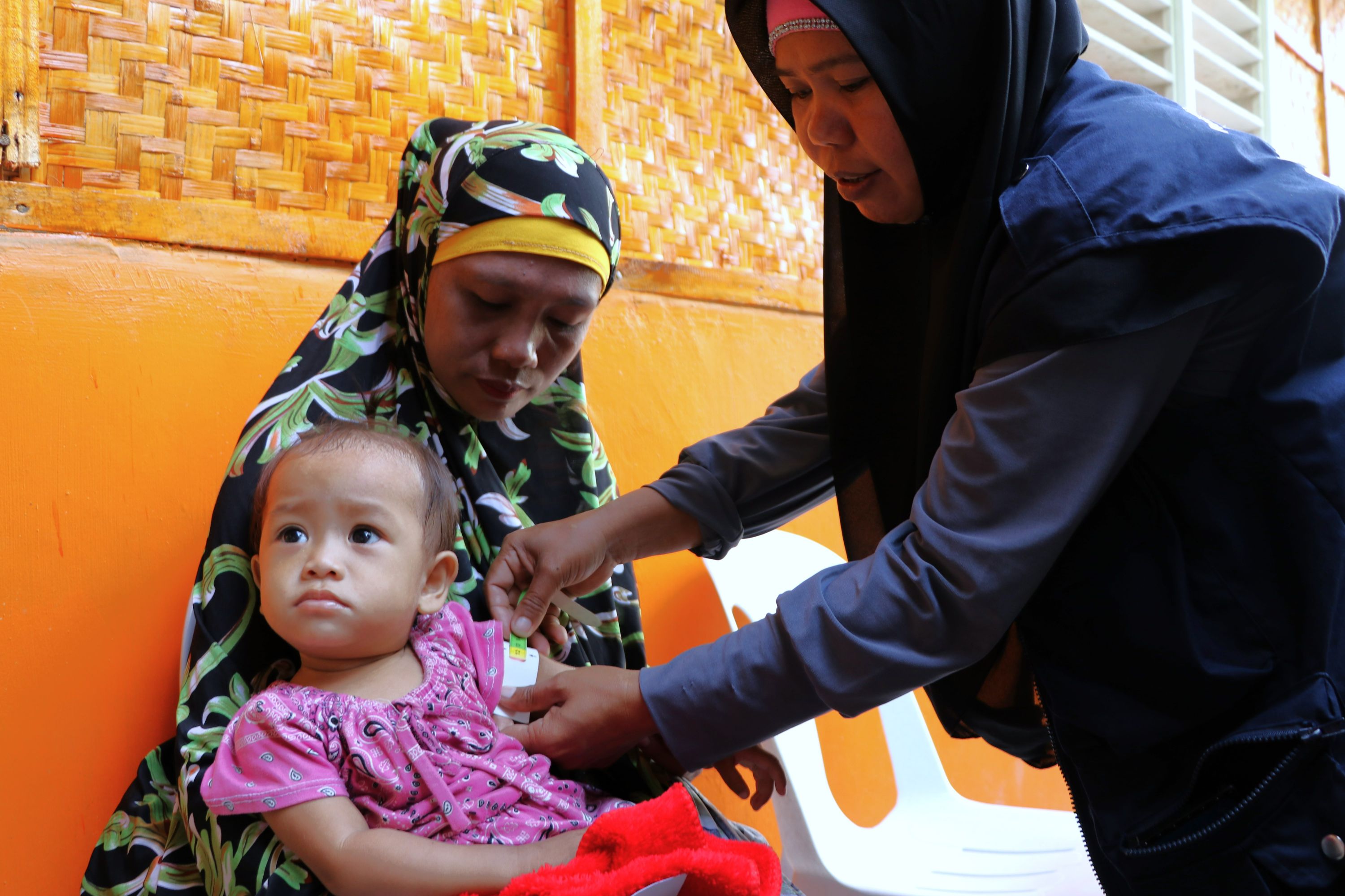 A WFS facilitator checks for malnutrition among the children of Talitay, Maguindanao del Norte.