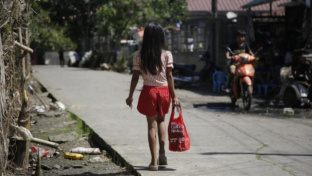 A teenage girl heads home after receiving a Menstrual Hygiene Management (MHM) Kit—supported by the Australian Government—after Typhoon Trami (local name: Kristine). Courtesy of ADRA Philippines
