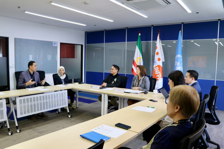 A group of people in a meeting room