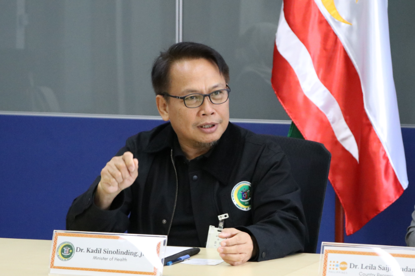 A photo of BARMM Minister of Health while talking to the people in the meeting room