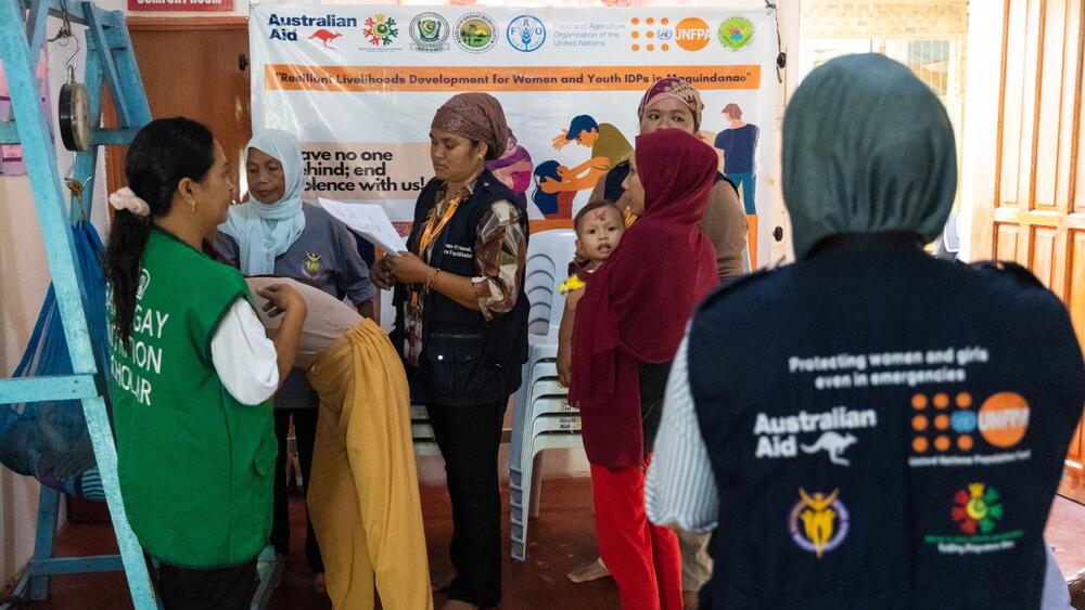 Women-Friendly Space facilitators work together with local health workers in monitoring vital statistic of toddlers ©UNFPA Philippines/Ferdh Cabrera