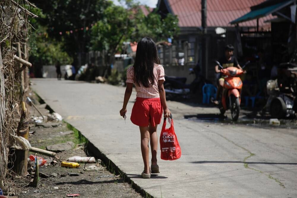 Teen girl walks back home with her kit