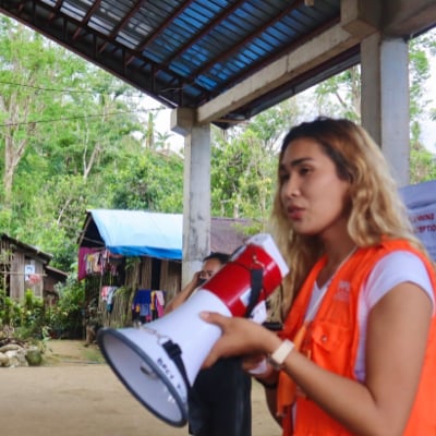 Humanitarian aid worker making announcements using a megaphone