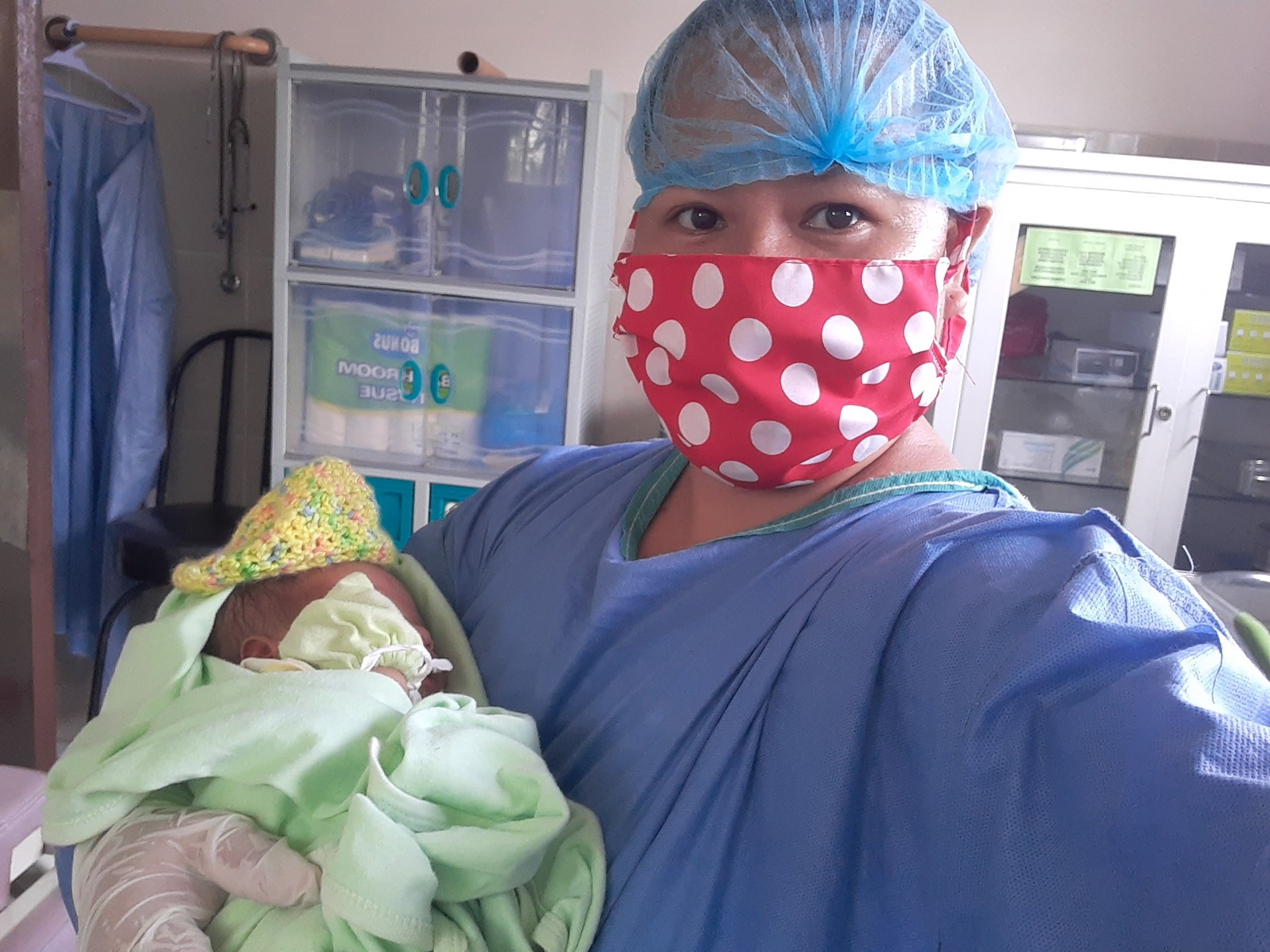 Safe in her arms. The baby born  at 2:30 AM at home is transferred to their birthing clinic for monitoring and care. 