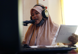 Bailan delivers information on women's health, rights, and COVID-19 through their community radio program. | Photo by Jeoff Mait