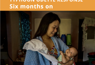 A woman carrying her baby in Southern Leyte Philippines UNFPA Six Months Report Odette Response