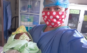 Safe in her arms. The baby born  at 2:30 AM at home is transferred to their birthing clinic for monitoring and care. 