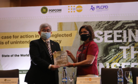 Dr. Leila Joudane, Country Representative of UNFPA Philippines, hands over the 2022 State of World Population Report to Mr. Anto