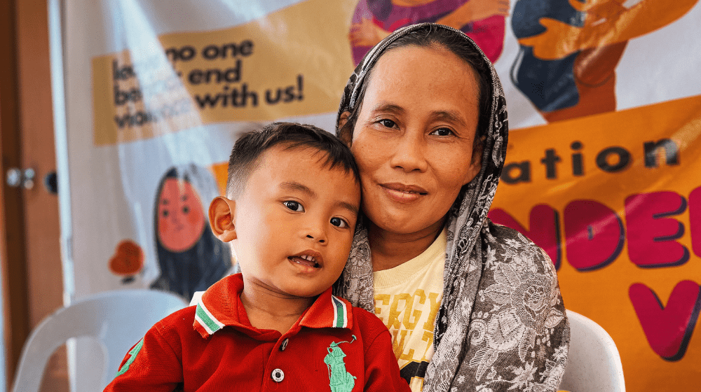 A rural woman from BARMM shares a smile with her grandson in a Women-Friendly Space.